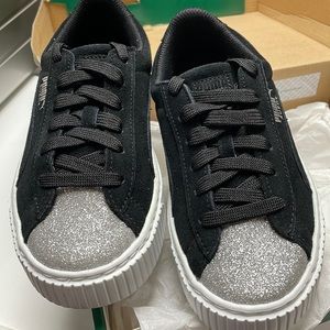 Puma black suede platform sneakers with a silver toe.